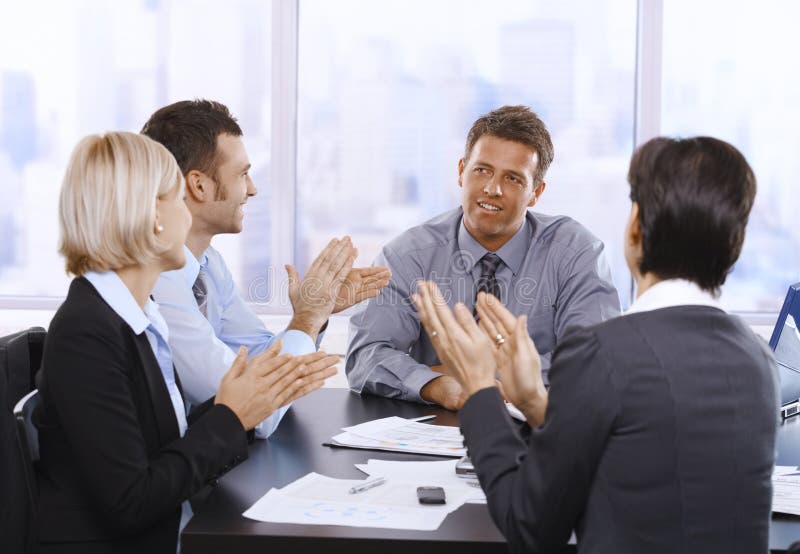Businesspeople clapping hands, smiling and celebrating at meeting. Boardroom table clapping stock images, royalty-free photos and pictures