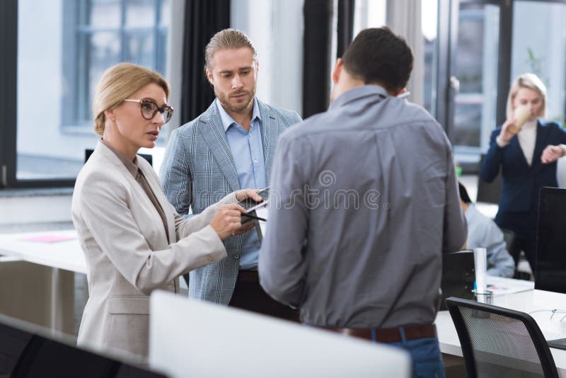 Businesspeople discussing work in office