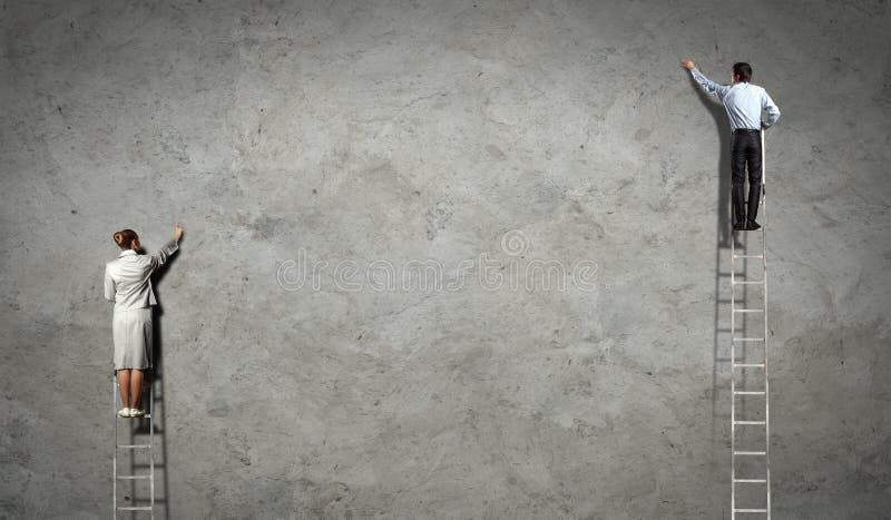 Businesspeople drawing diagrams on wall