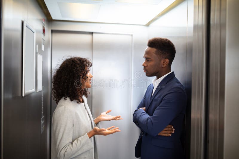 Businesspeople Having Conversation in Elevator Stock Photo Image of