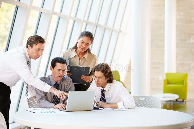 Businesspeople Having Meeting Around Table In Modern Office stock images Businesspeople Having Meeting Around Table In Modern Office stock images