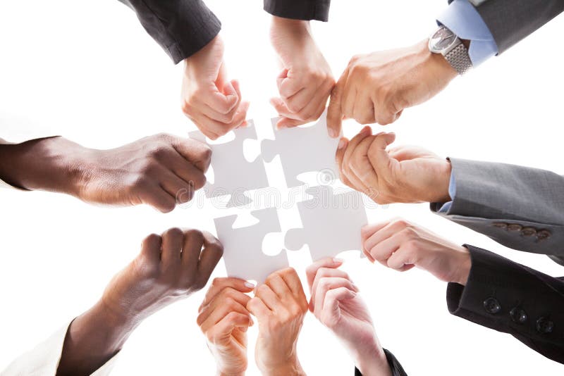 Businesspeople Holding Jigsaw Puzzle