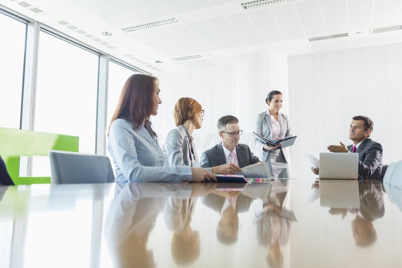 Businesspeople in a meeting. Standing file folder stock images, royalty-free photos and pictures
