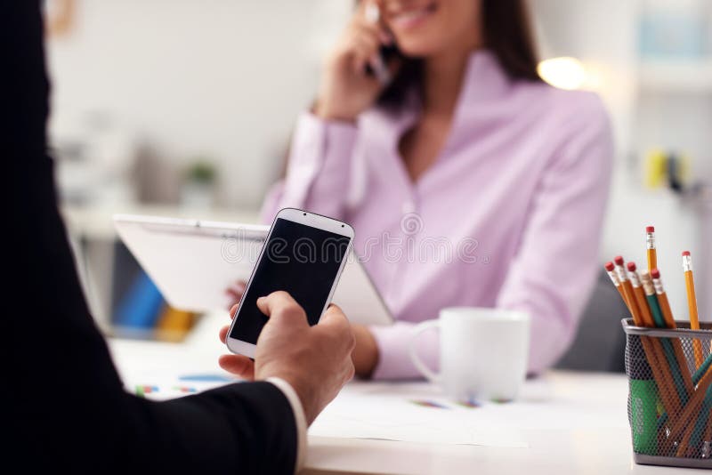 Businesspeople Using Smartphones in Office Stock Image Image of text