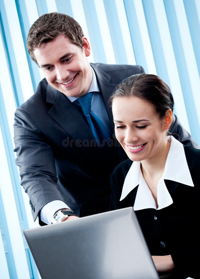 Two businesspeople working with laptop