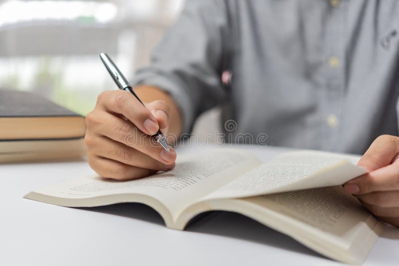 Businessperson Reading and Writing on Book.education Studying Knowledge