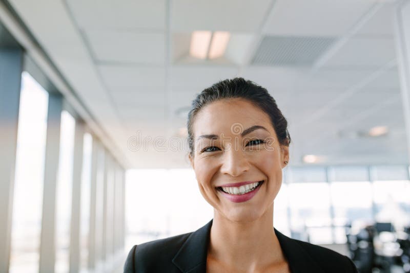 Portrait of beautiful mature businesswoman standing in office and smiling. Asian female entrepreneur looking at camera with big smile on her face. Portrait of beautiful mature businesswoman standing in office and smiling. Asian female entrepreneur looking at camera with big smile on her face.