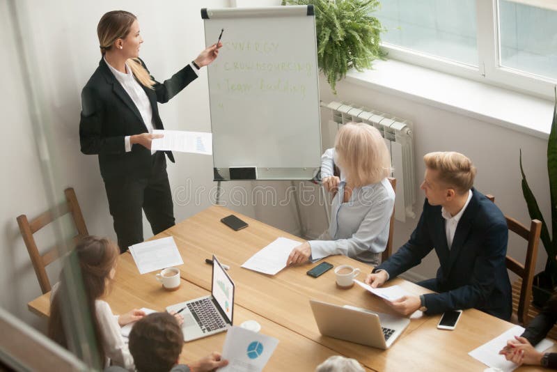 Businesswoman leader giving presentation explaining team goals a stock photography