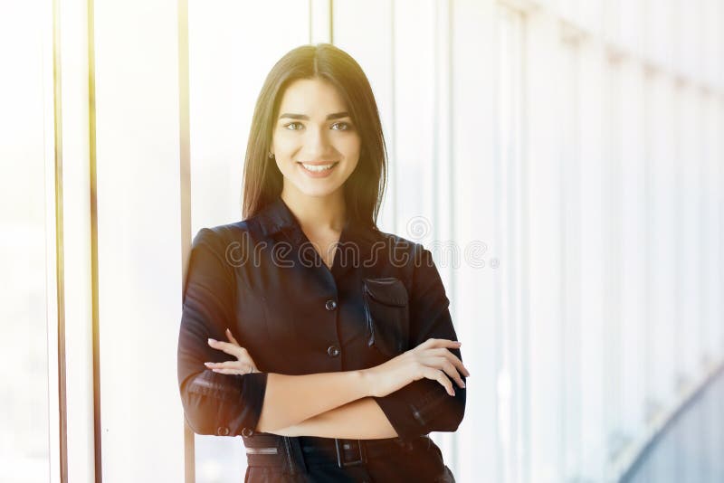 Businesswoman crossed hands portrait in office with panormic windows. stock photos Businesswoman crossed hands portrait in office with panormic windows. stock photos