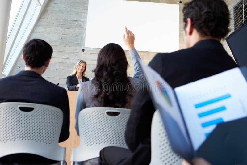 Businesswoman Delivering Presentation At Conference Smiling. Smiling asking stock images, royalty-free photos and pictures