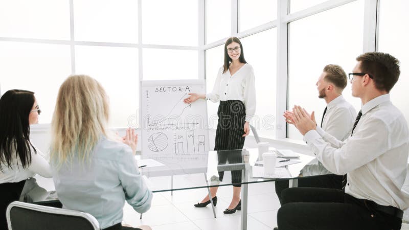 Businesswoman discusses with the business team a new business strategy. stock image Businesswoman discusses with the business team a new business strategy. stock image