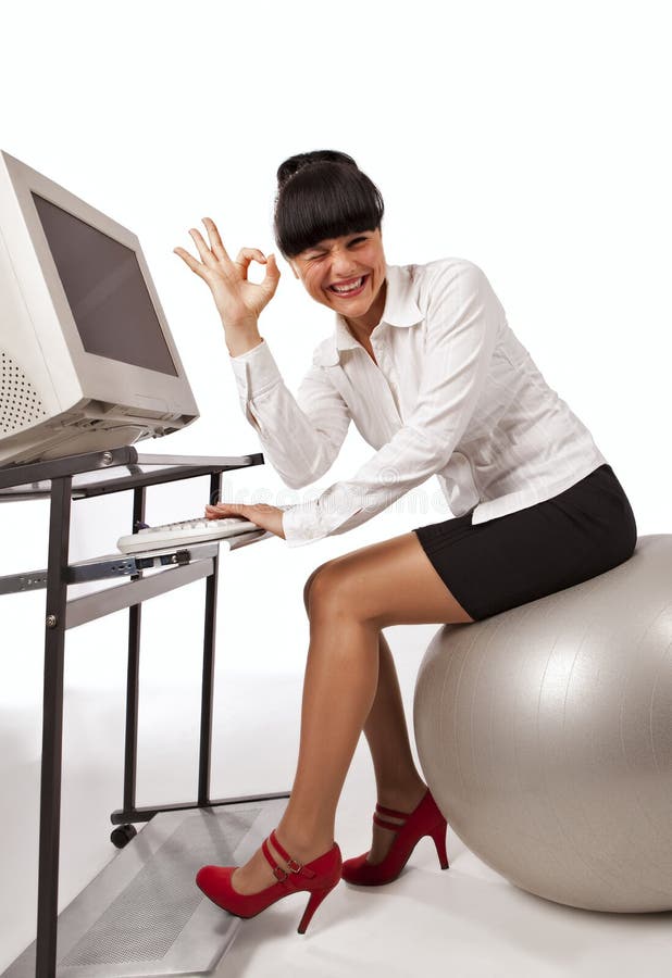 Businesswoman doing exercise with ball