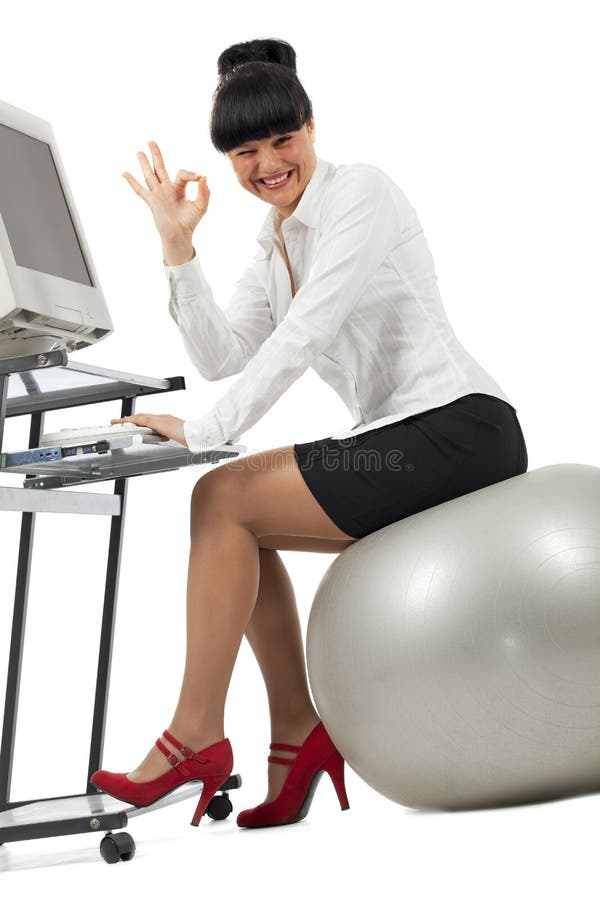 Businesswoman doing exercise with a ball