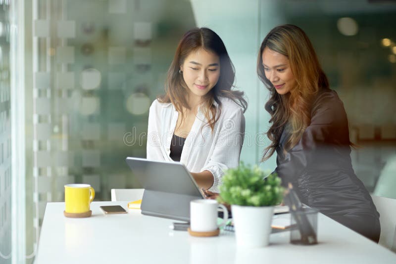 Businesswoman explaining online project instructing new assistant stock images