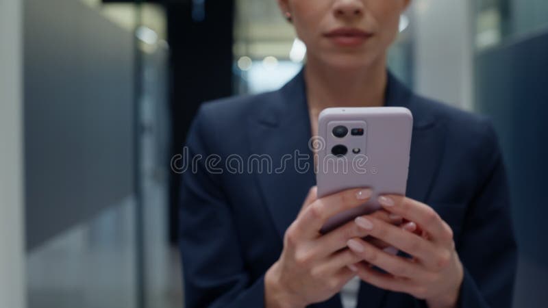 Businesswoman hands holding cellphone in vestibule closeup. Woman messaging stock footage