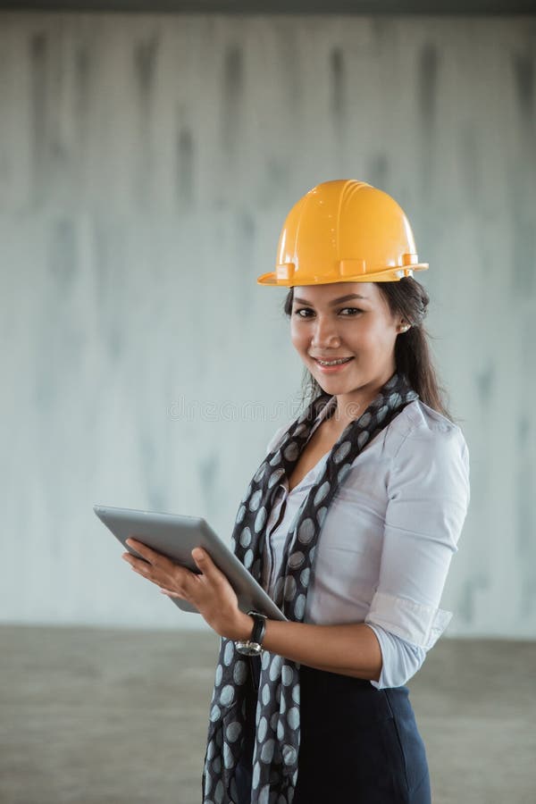 Businesswoman with Hardhat Using Tablet Pc in the Project Site Stock Image - Image of female ...
