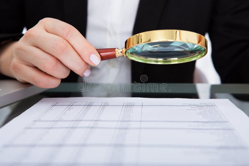 Businesswoman Looking At Document Through Magnifying Glass. Detective paperwork stock images, royalty-free photos and pictures