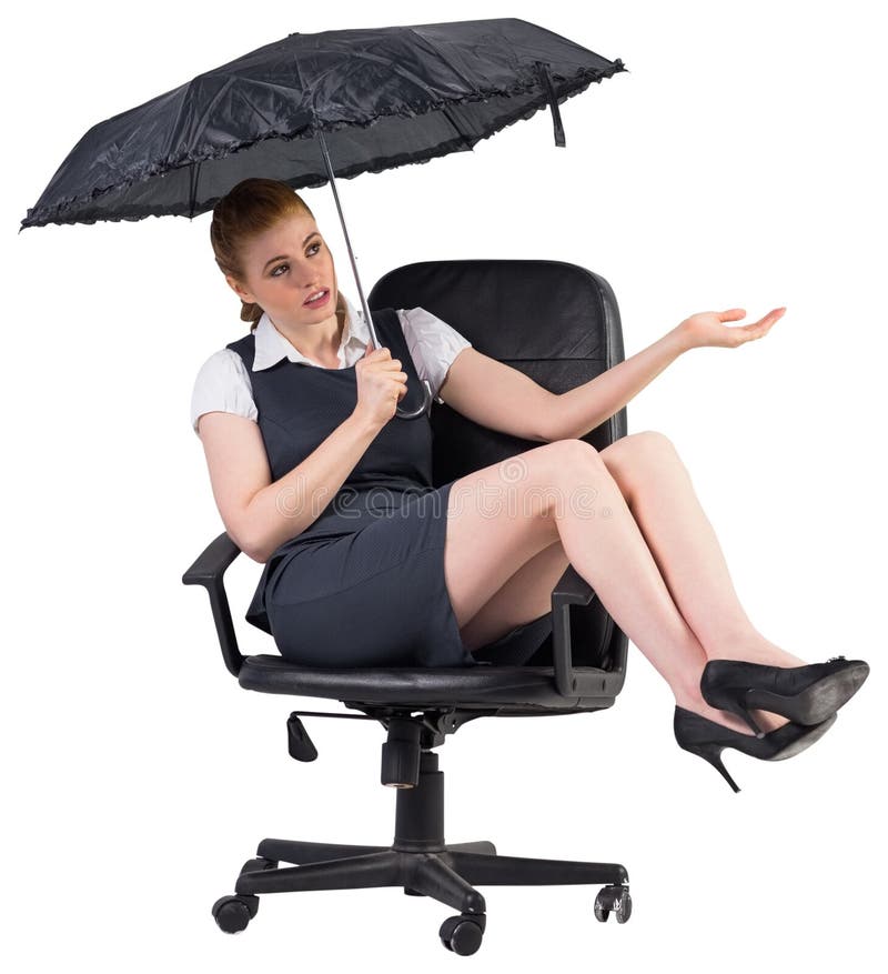 Businesswoman holding umbrella sitting on swivel chair on white background