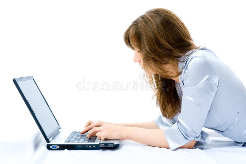 Businesswoman with laptop lying on the floor.