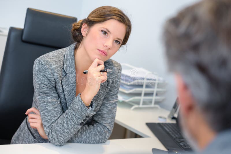 Businesswoman listening attentively to male client stock photos Businesswoman listening attentively to male client stock photos