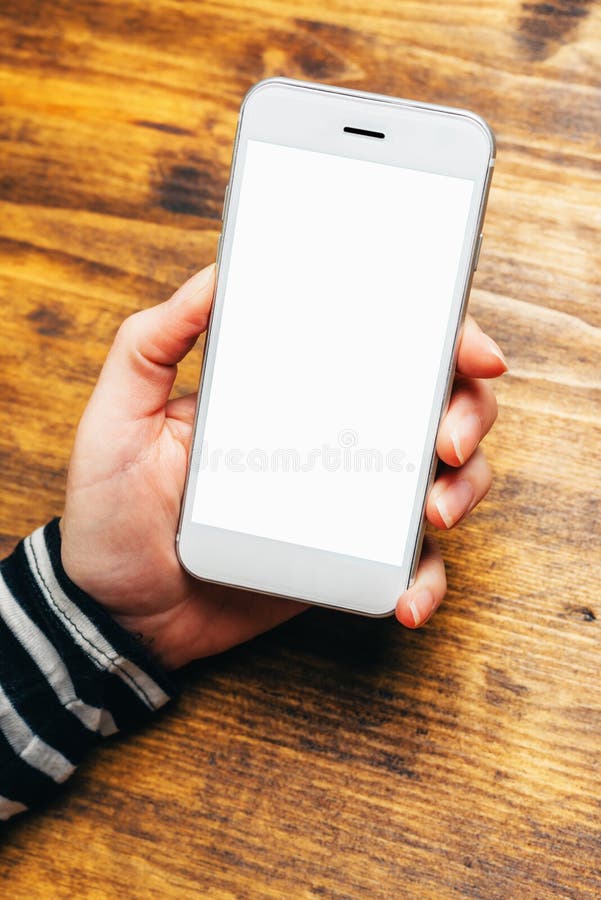 Businesswoman looking at blank screen of white smartphone in off stock image Businesswoman looking at blank screen of white smartphone in off stock image
