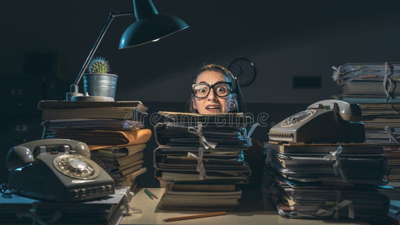 Businesswoman overloaded with paperwork