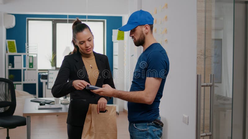 Businesswoman paying with contactless credit card takeaway delivery food meal order