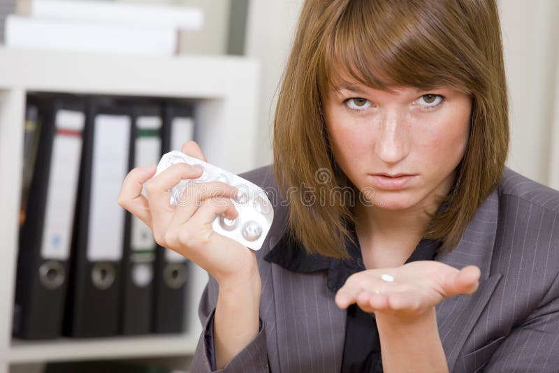 Businesswoman with pills