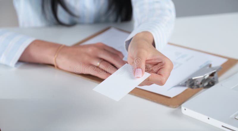 Businesswoman showing and handing a blank business card. woman in black suit Isolated on white background