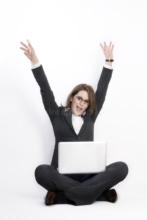 Businesswoman sitting on the floor with laptop.