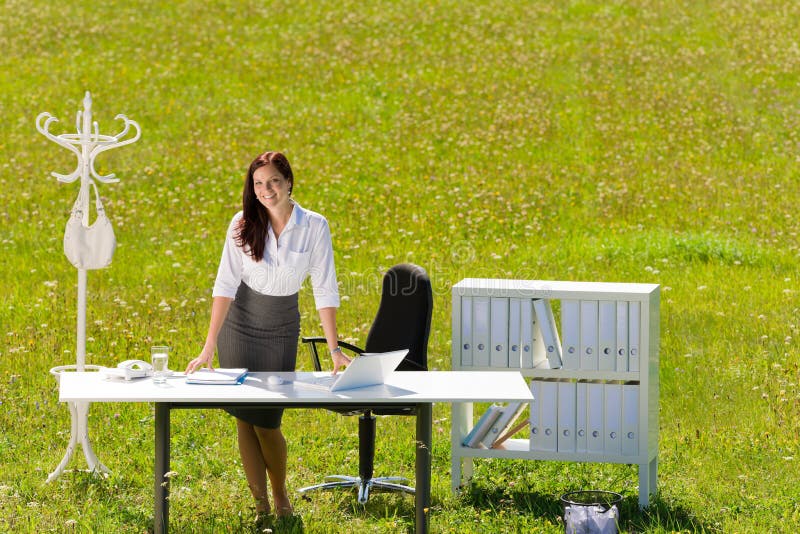 Businesswoman in sunny meadow nature office smile