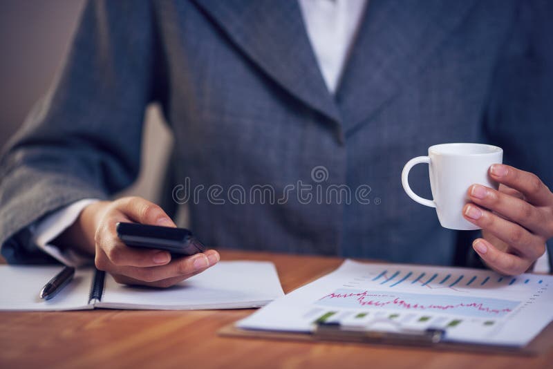 Businesswoman text messaging in office stock images