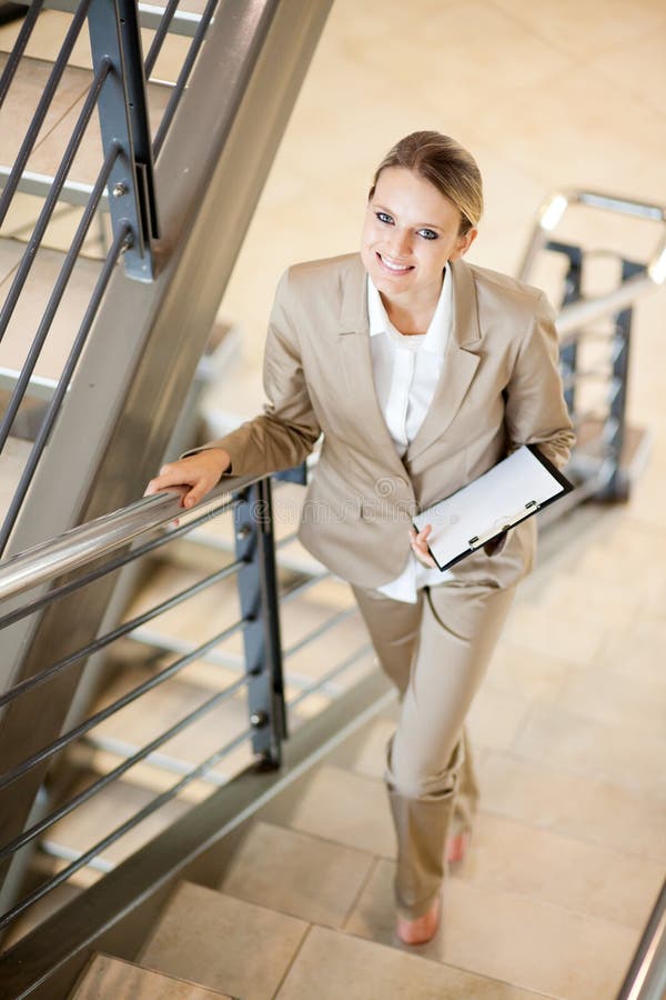 Gorgeous young businesswoman walking up stairs. Lovely european female stock images, royalty-free photos and pictures