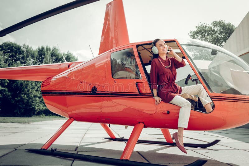 Businesswoman wearing beige trousers leaving little private helicopter royalty free stock images Businesswoman wearing beige trousers leaving little private helicopter royalty free stock images