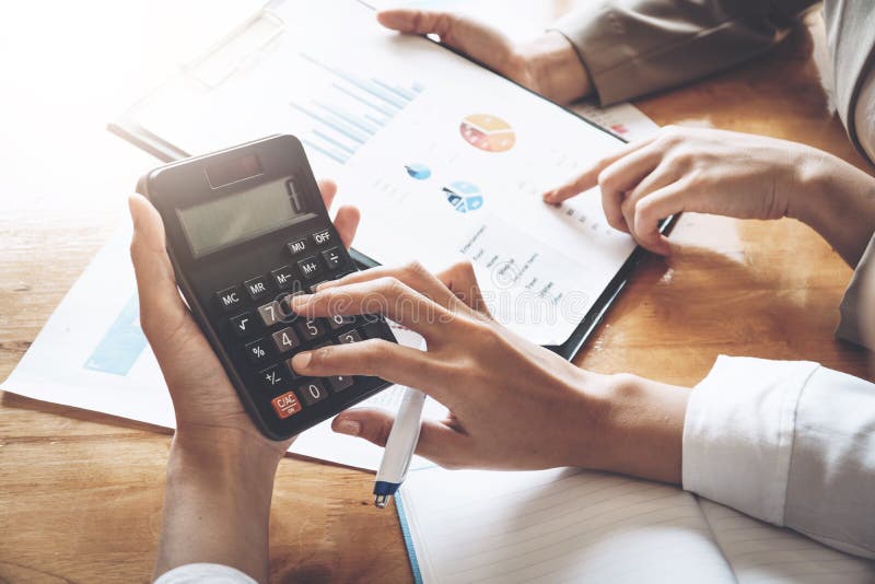 Businesswoman working on calculator to calculate business data t