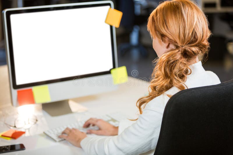 Businesswoman working on computer royalty free stock images