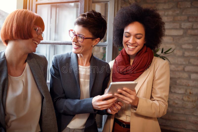 Businesswoman working together on tablet in office stock photography Businesswoman working together on tablet in office stock photography