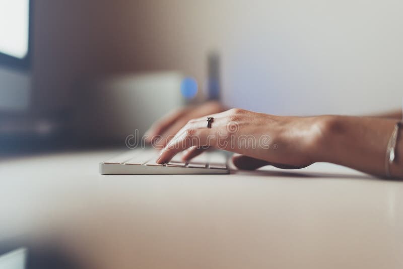 Businesswomen working at office with monitor computer, young hipster manager typing on keyboard, closeup finger female hands text royalty free stock photography Businesswomen working at office with monitor computer, young hipster manager typing on keyboard, closeup finger female hands text royalty free stock photography