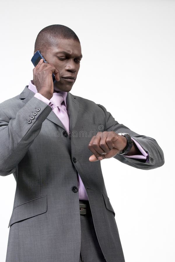 Black businessman on the phone checking time. Male hand holding businessman stock images, royalty-free photos and pictures