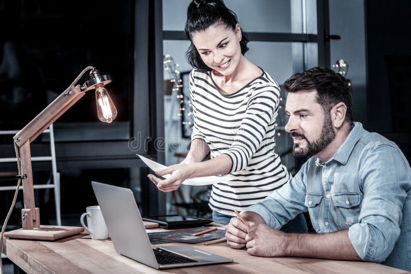 Busy friendly partners communicating and using the laptop. royalty free stock images Busy friendly partners communicating and using the laptop. royalty free stock images