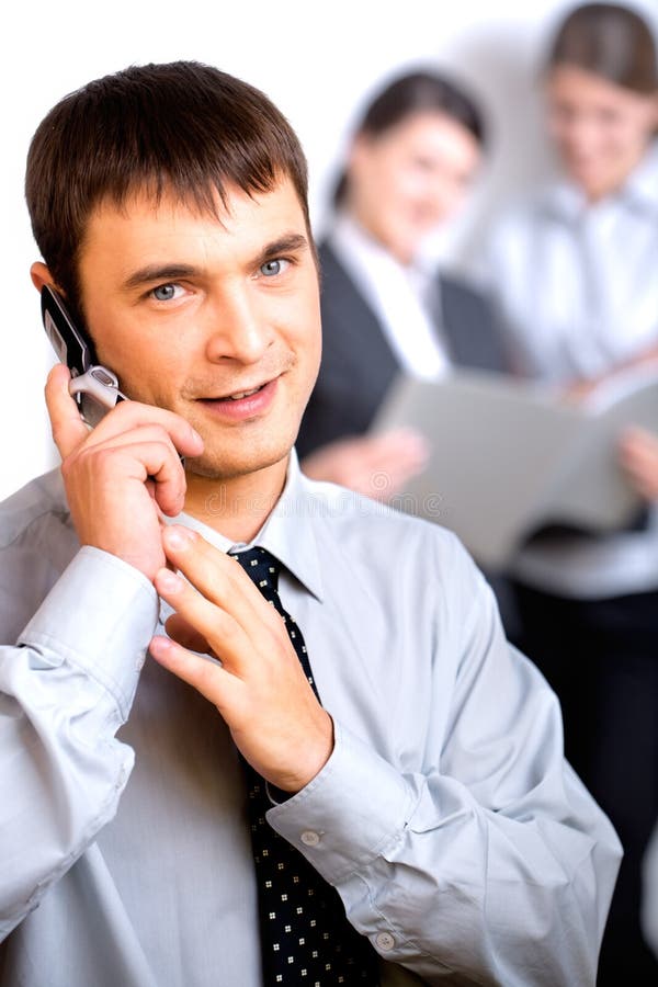 Successful business man calling on cellphone on the background of women. Successful business man calling on cellphone on the background of women