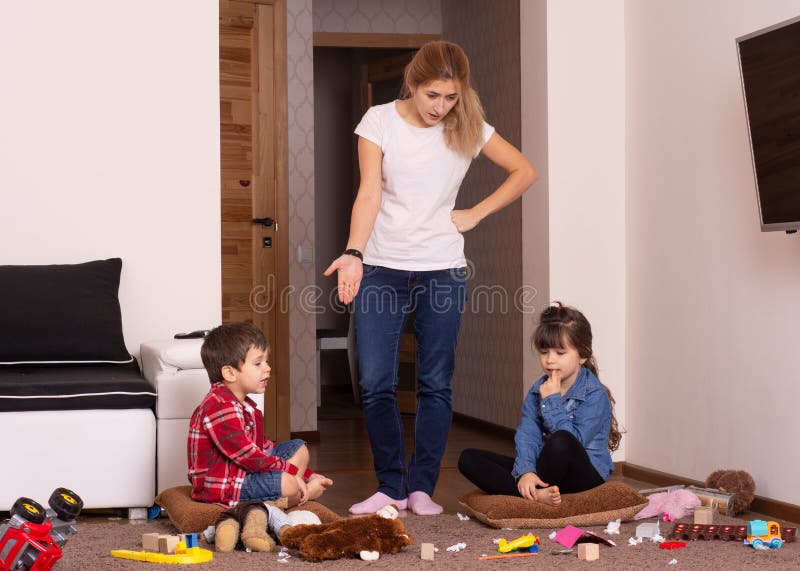 Busy mom. Mom tired to tidy up the house. Child scattered toys. Mess in the house.