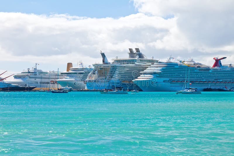 PHILIPSBURG, ST. MAARTEN - JAN.16: Cruise ships docked on the Dutch side of St. Maarten on Jan. 16, 2013. Philipsburg is one of the busiest islands as the port can accommodate half dozen ships. PHILIPSBURG, ST. MAARTEN - JAN.16: Cruise ships docked on the Dutch side of St. Maarten on Jan. 16, 2013. Philipsburg is one of the busiest islands as the port can accommodate half dozen ships.