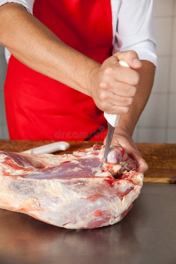 Butcher Cutting Meat With Boning Knife