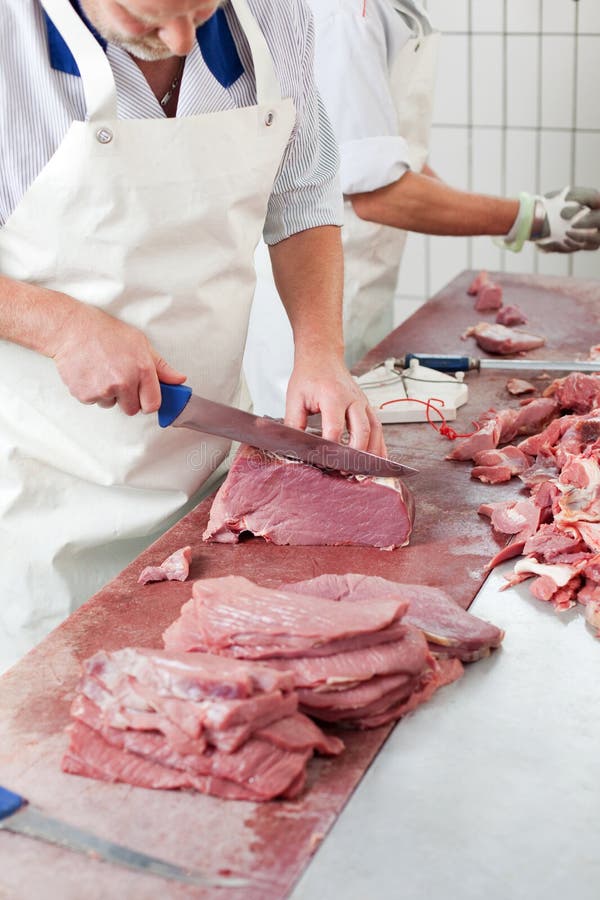 Butcher cutting meat