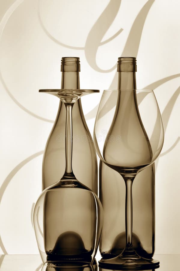 silhouetted bottles of wine and glasses against graphic abstract background. silhouetted bottles of wine and glasses against graphic abstract background