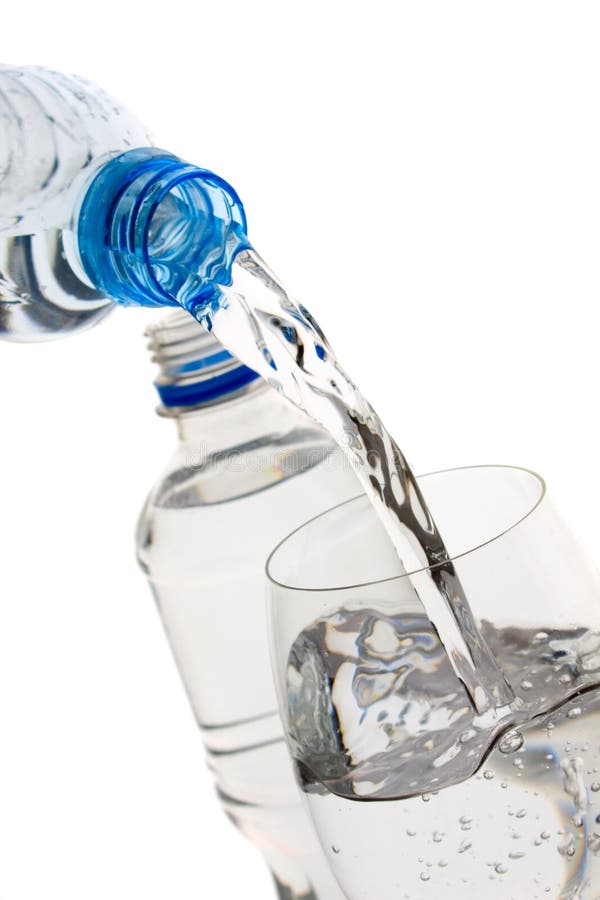 Bottled water poured in a glass isolated on white background. Bottled water poured in a glass isolated on white background