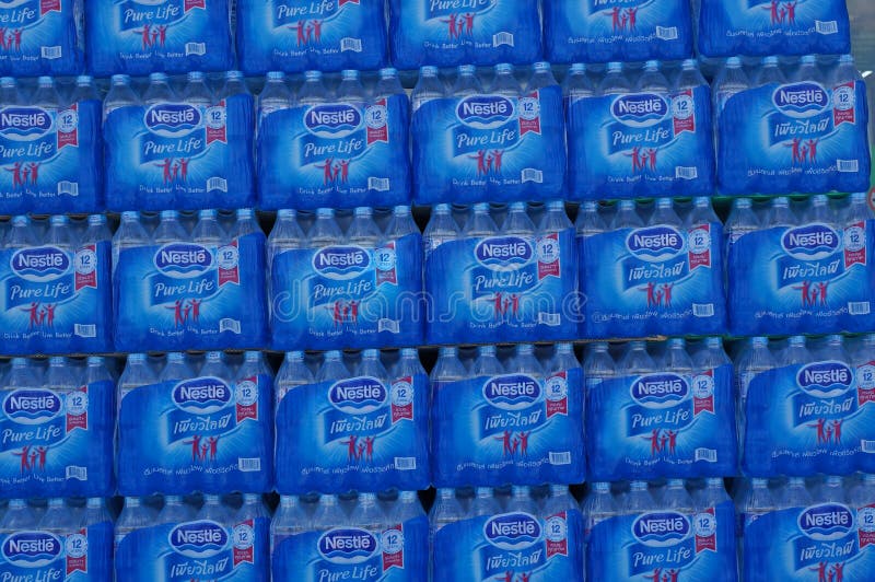 The Bottled water Brand Nestle Pure Life at front of TESCO LOTUS Express at Bangkok in Thailand. The Bottled water Brand Nestle Pure Life at front of TESCO LOTUS Express at Bangkok in Thailand.