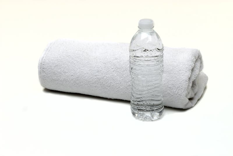 White towel with a Hand Weights & bottled water. White towel with a Hand Weights & bottled water