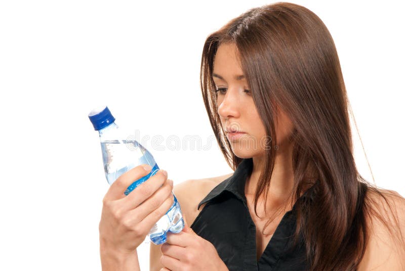 Woman reading lable bottle of pure still drinking water nutrition facts. Female hold in hand sparkling mineral bottled water isolated on a white background. Healthy lifestyle concept. Woman reading lable bottle of pure still drinking water nutrition facts. Female hold in hand sparkling mineral bottled water isolated on a white background. Healthy lifestyle concept